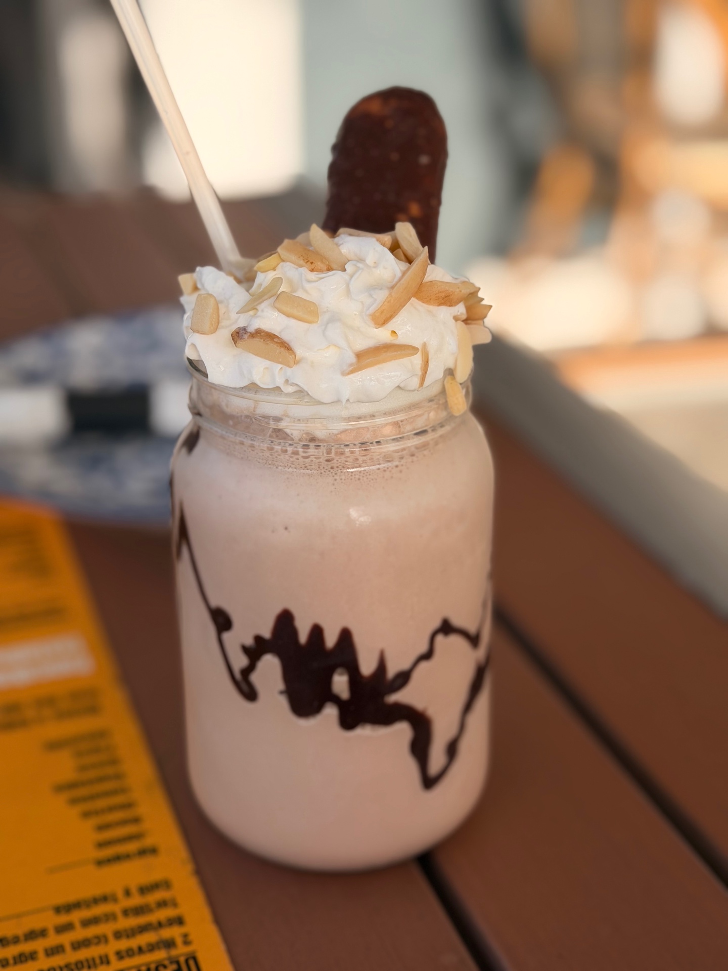 Hand-spun milkshake with whipped cream, almonds and chocolate drizzle